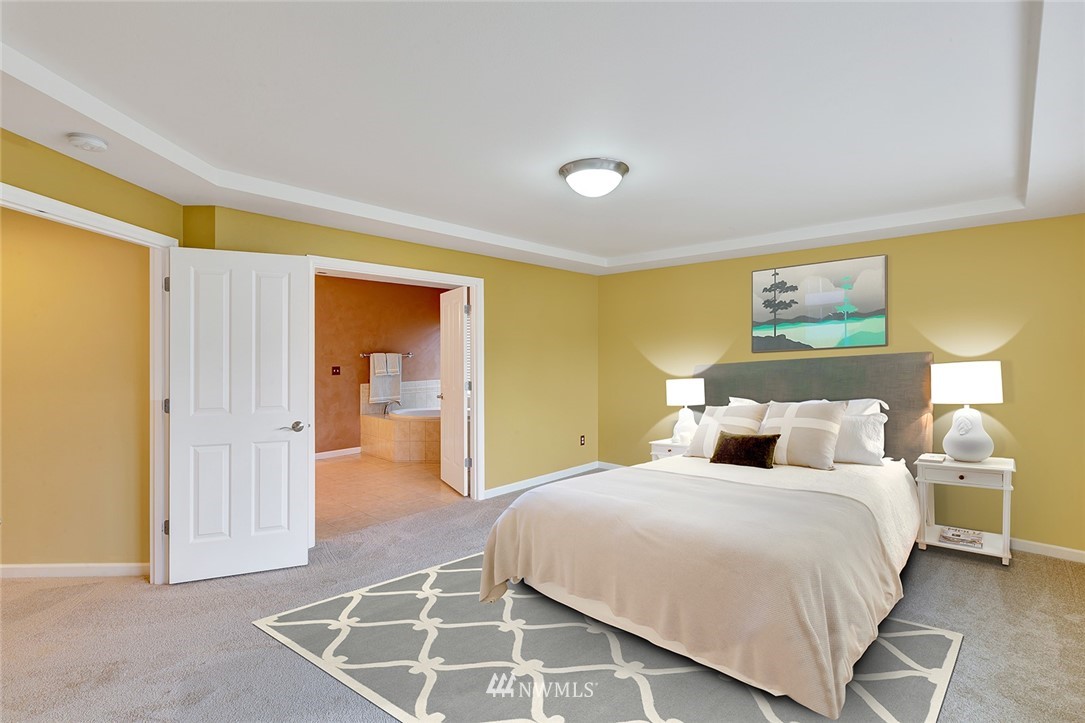 3617 156th Place Southeast Bothell, WA 98012 - Photo 8 of 18 a bedroom with a bed and walk in closet
