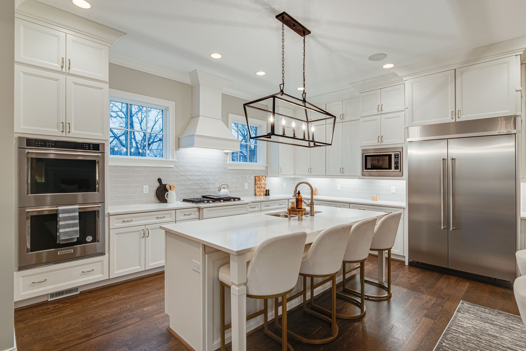 4220 Kirtland Road Nashville, TN 37215 - Photo 18 of 55 a kitchen with refrigerator cabinets dining table and chairs