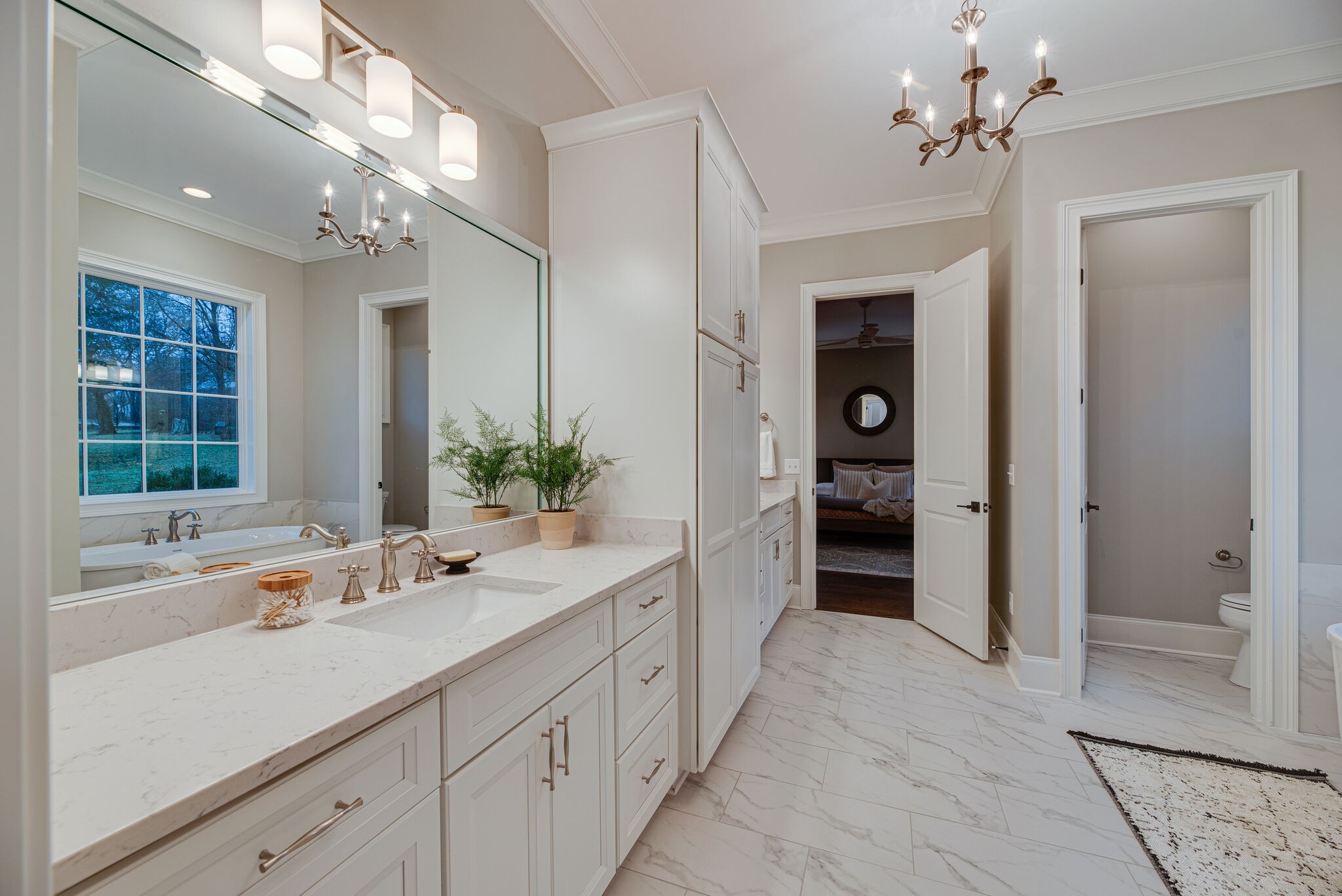 4220 Kirtland Road Nashville, TN 37215 - Photo 35 of 55 a spacious en suite bathroom with a double vanity sink a large mirror and a bathtub
