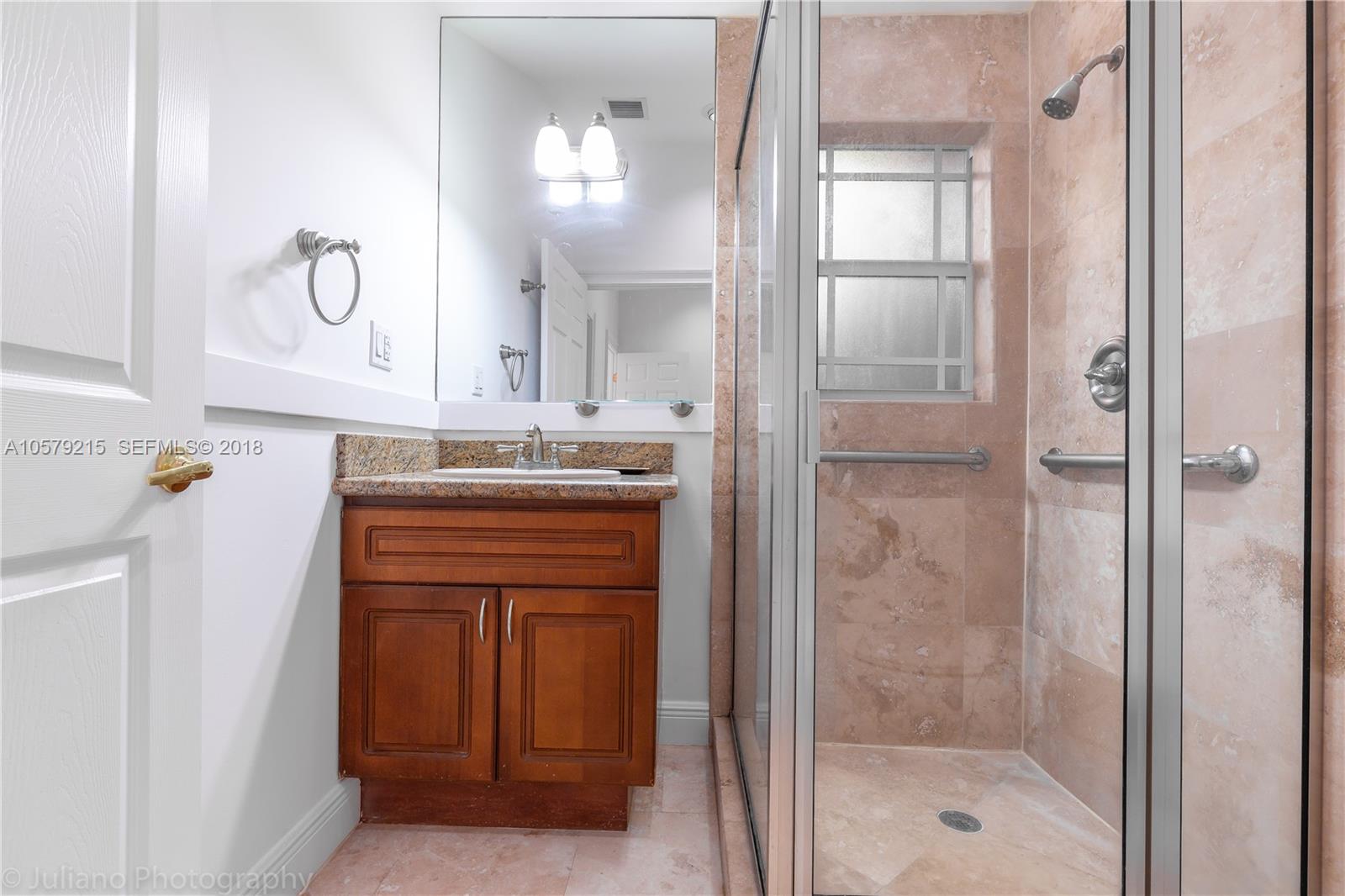 211 Southwest 29th Road Miami, FL 33129 - Photo 19 of 33 a bathroom with a granite countertop sink a mirror and a shower