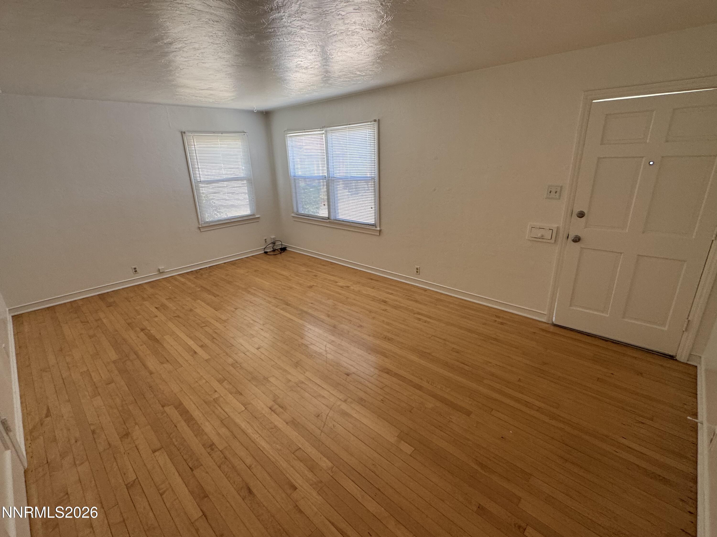 70 Arden Circle Reno, NV 89503 - Photo 2 of 15 an empty room with wooden floor and windows