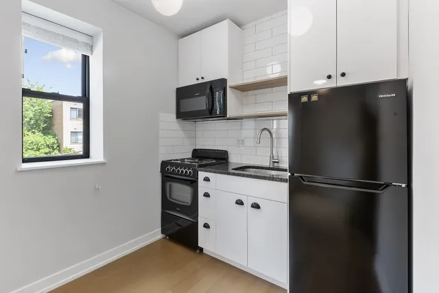 a kitchen with stainless steel appliances a refrigerator and a stove top oven