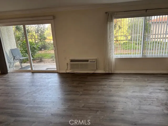 a view of room with window and wooden floor