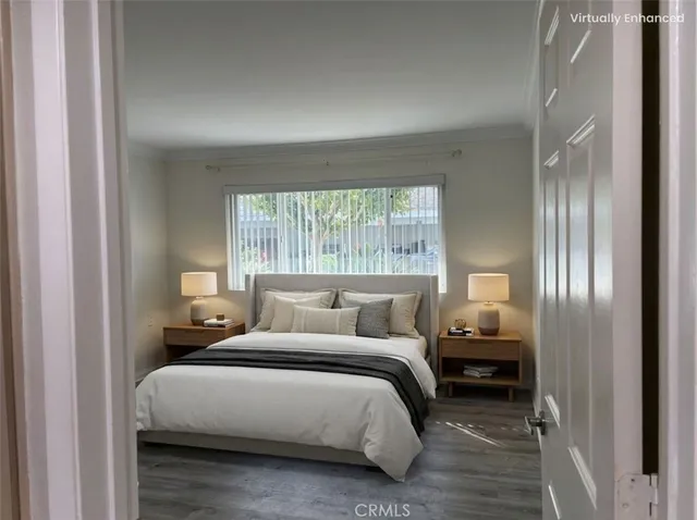 a bedroom with a bed and a large window