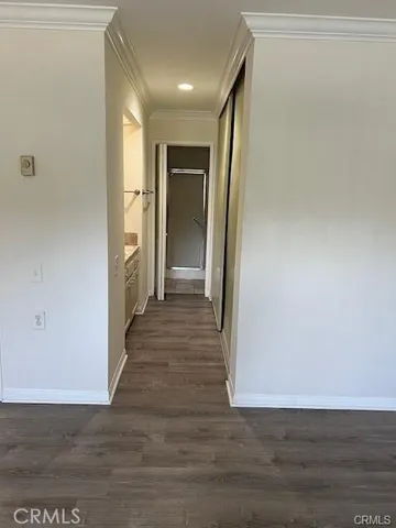 a view of a hallway with wooden floor