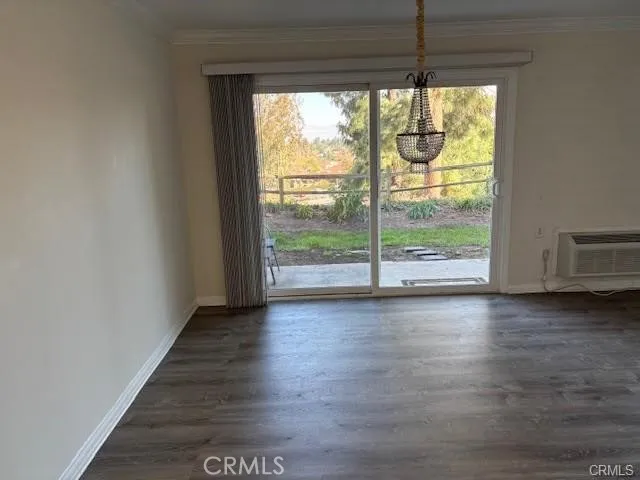 a view of room with window and wooden floor
