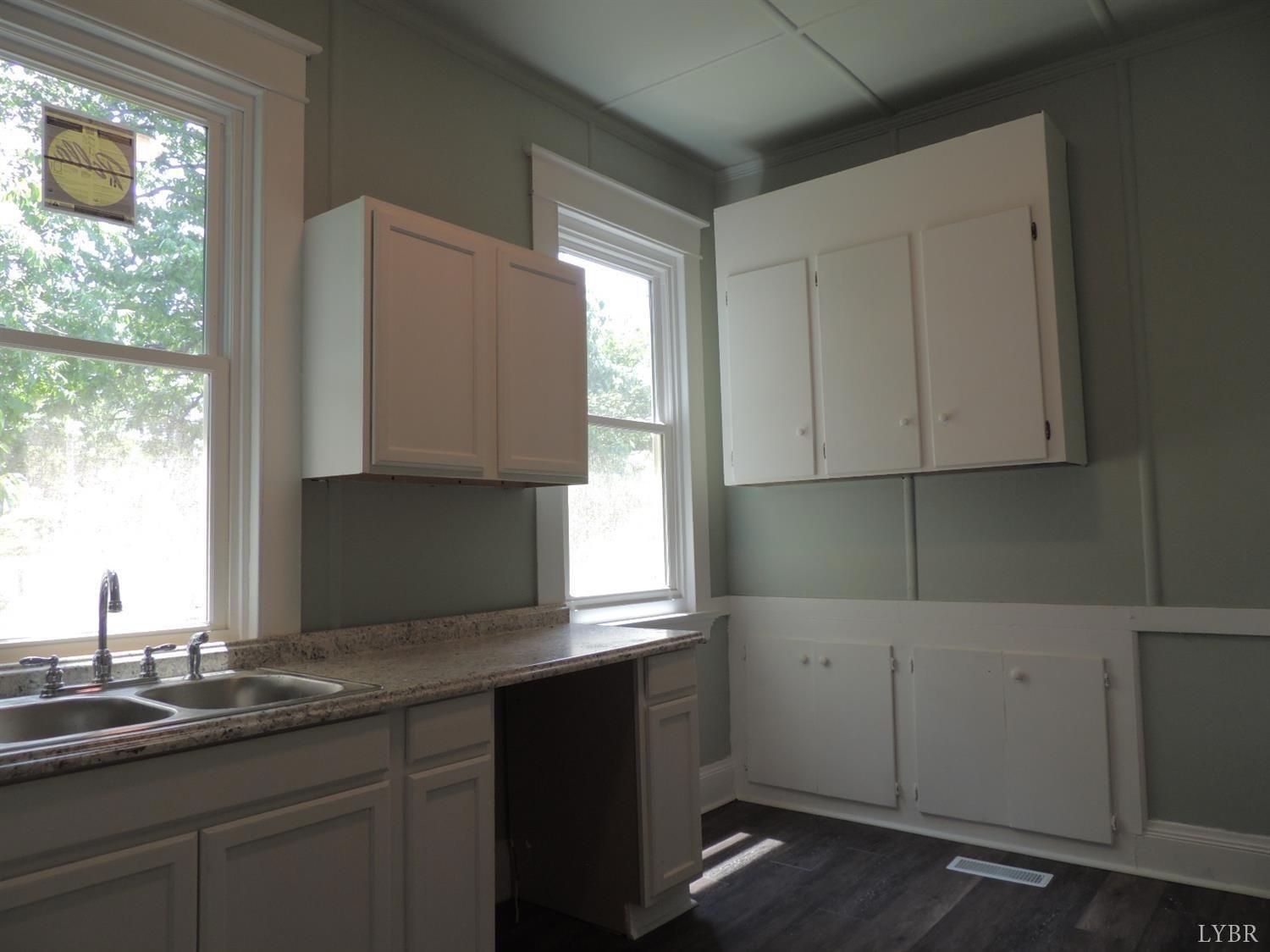 7007 Wards Road Rustburg, VA 24588 - Photo 12 of 26 a kitchen with a sink cabinets and window