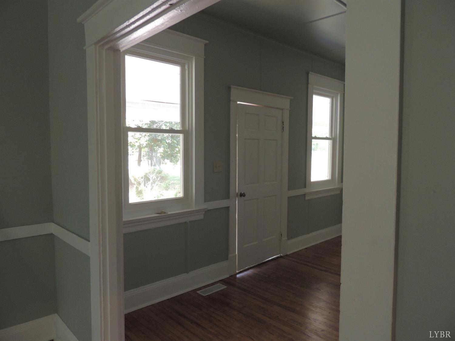 7007 Wards Road Rustburg, VA 24588 - Photo 14 of 26 a view of an empty room with wooden floor and a window
