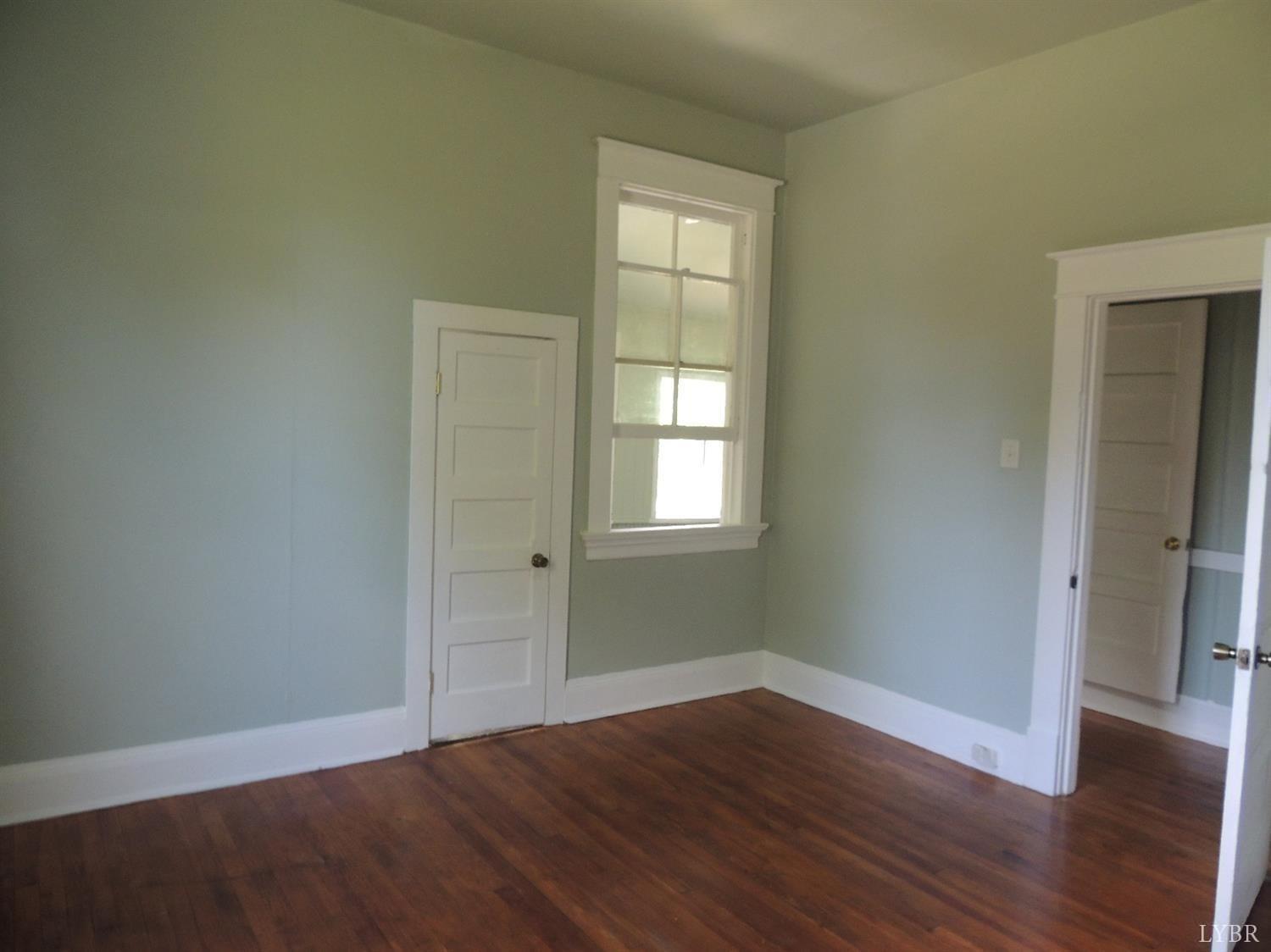 7007 Wards Road Rustburg, VA 24588 - Photo 15 of 26 an empty room with wooden floor and windows