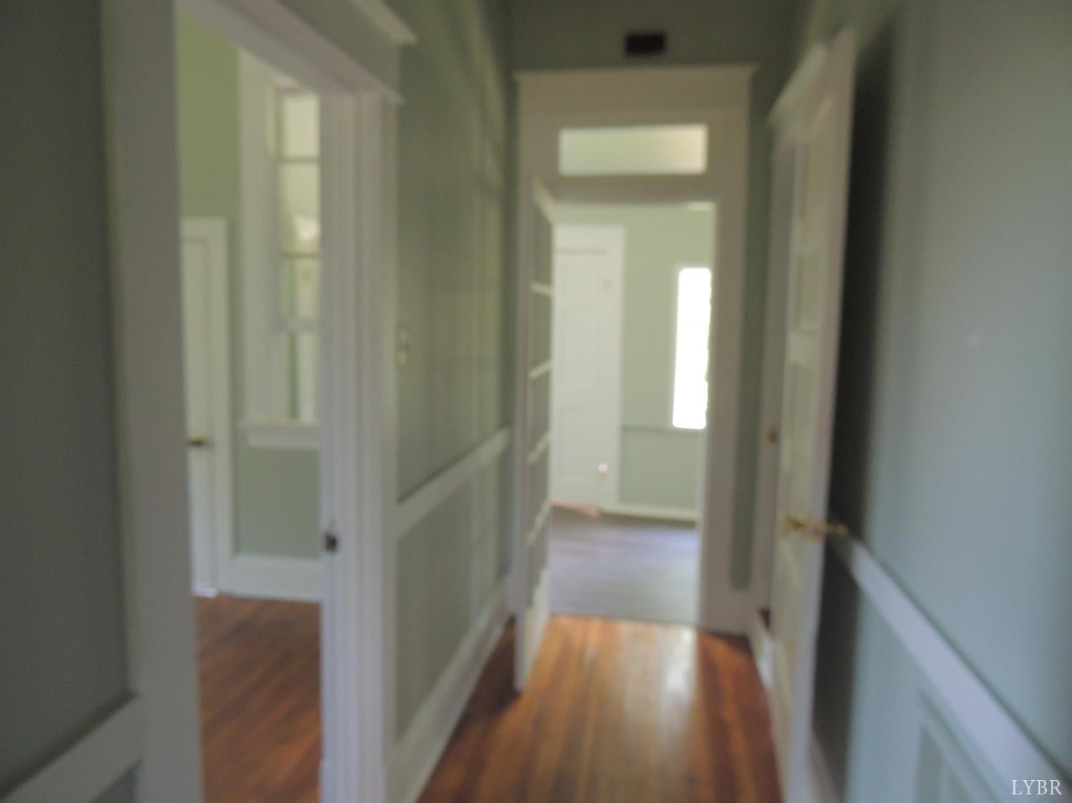 7007 Wards Road Rustburg, VA 24588 - Photo 16 of 26 a view of a hallway with wooden floor