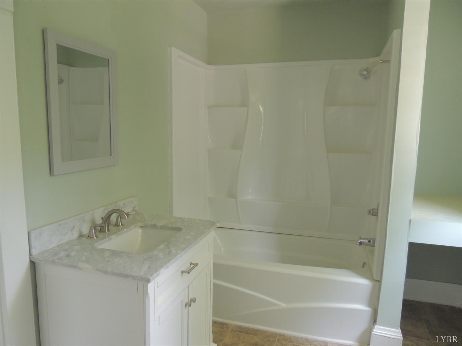 7007 Wards Road Rustburg, VA 24588 - Photo 21 of 26 a bathroom with a granite countertop sink and a bathtub