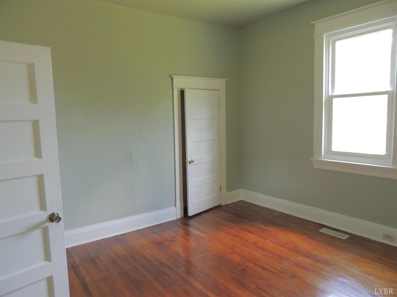 7007 Wards Road Rustburg, VA 24588 - Photo 22 of 26 a view of empty room with wooden floor and fan