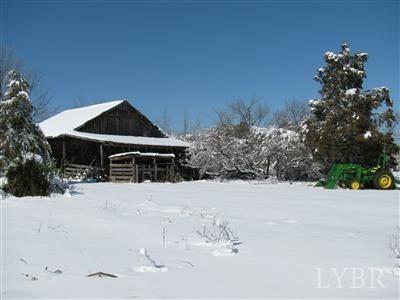 7007 Wards Road Rustburg, VA 24588 - Photo 24 of 26 a front view of a house with a yard covered with snow
