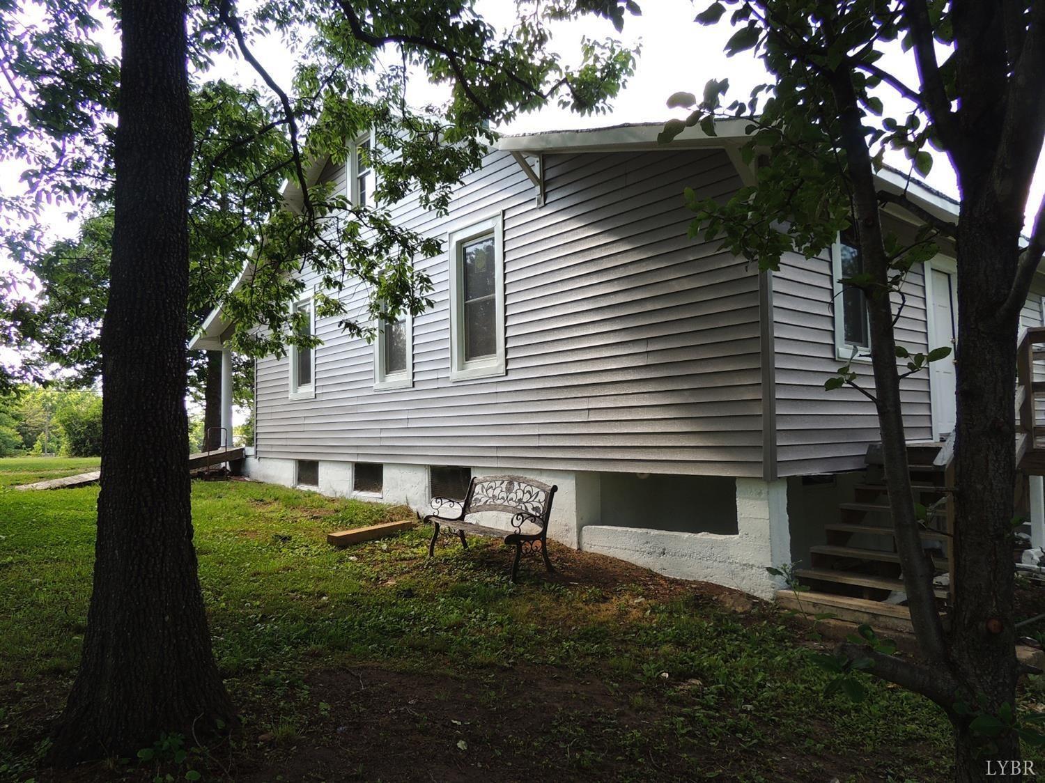 7007 Wards Road Rustburg, VA 24588 - Photo 9 of 26 a view of backyard with a garden and trees