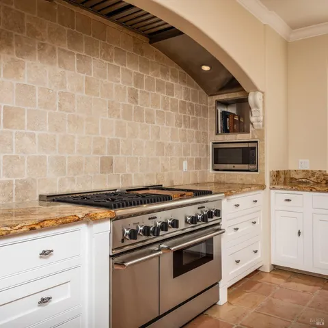 a white stove top oven sitting inside of a kitchen