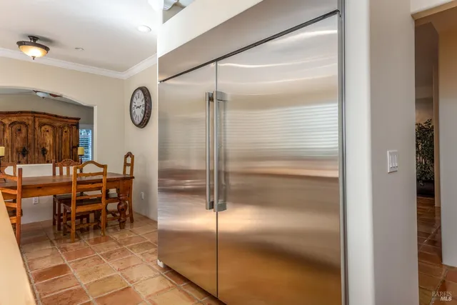 a kitchen with a refrigerator and a table