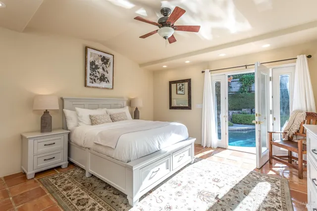 a bedroom with a large bed and a window