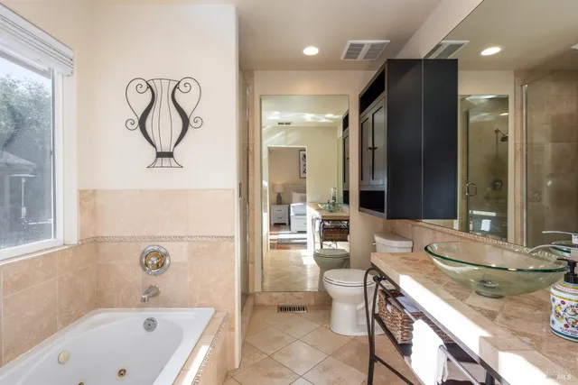 a bathroom with a bathtub sink and mirror