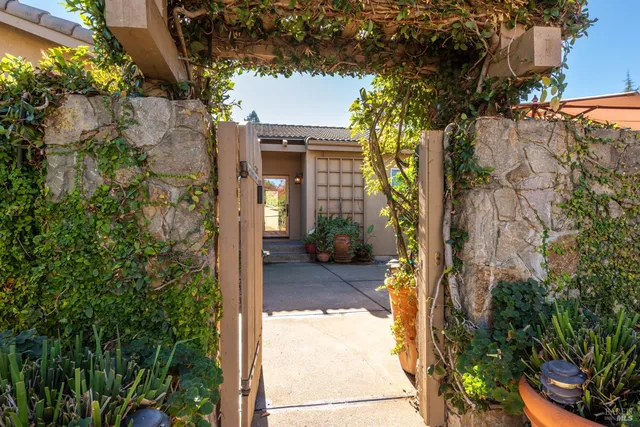 a view of a house with a tree next to a yard