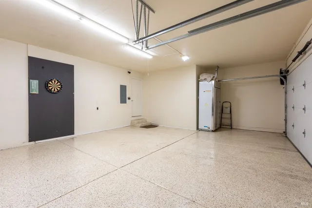 a view of a livingroom with a ceiling fan window and a hallway