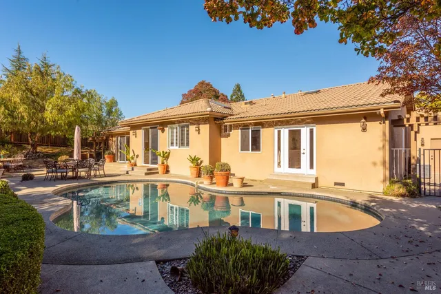 a view of a patio with swimming pool table and chairs