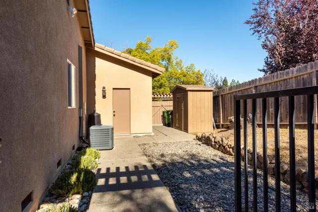 a view of a house with backyard and wooden fence