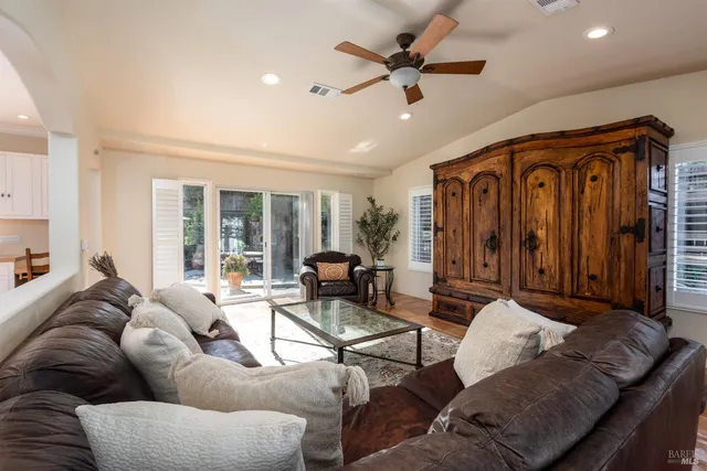 a living room with furniture ceiling fan and a rug