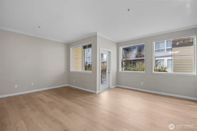 a view of wooden floor and windows in a room