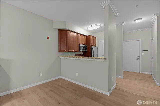 a kitchen with granite countertop a sink stainless steel appliances and cabinets