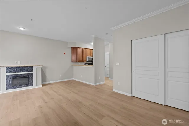 a view of an empty room with a window and fireplace