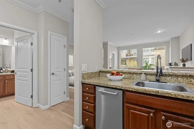 a kitchen with stainless steel appliances granite countertop a sink and a refrigerator