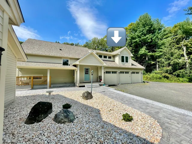 a front view of a house with a garden