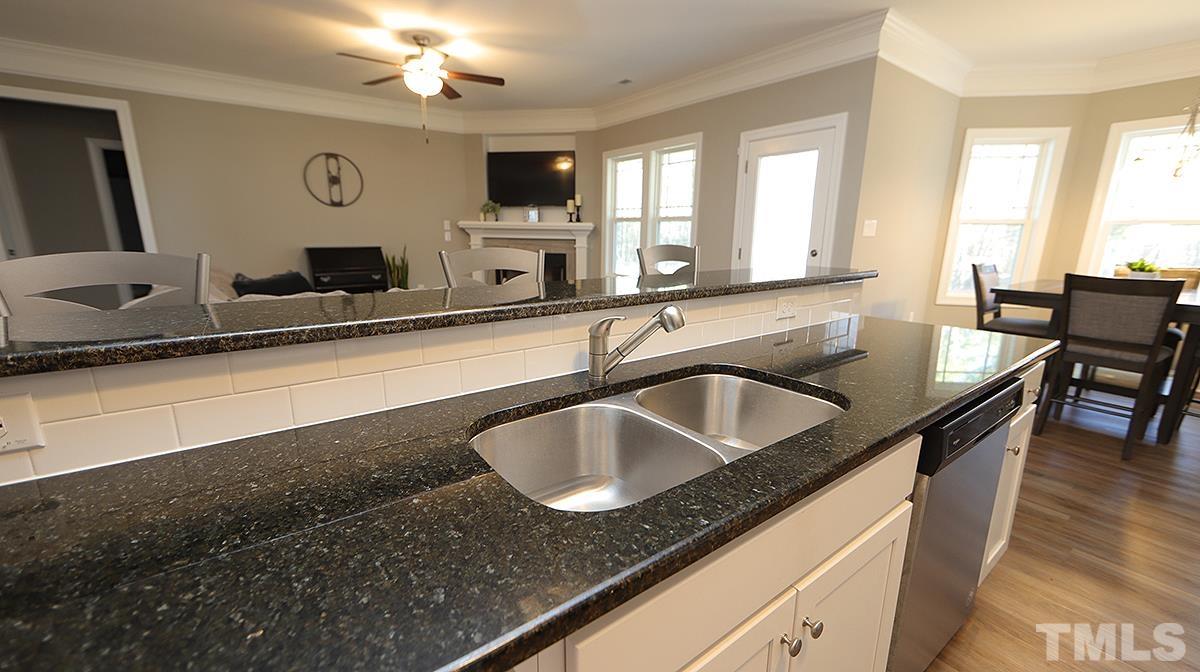 74 Flora Drive Benson, NC 27504 - Photo 12 of 33 a kitchen with a sink a counter top space and a window