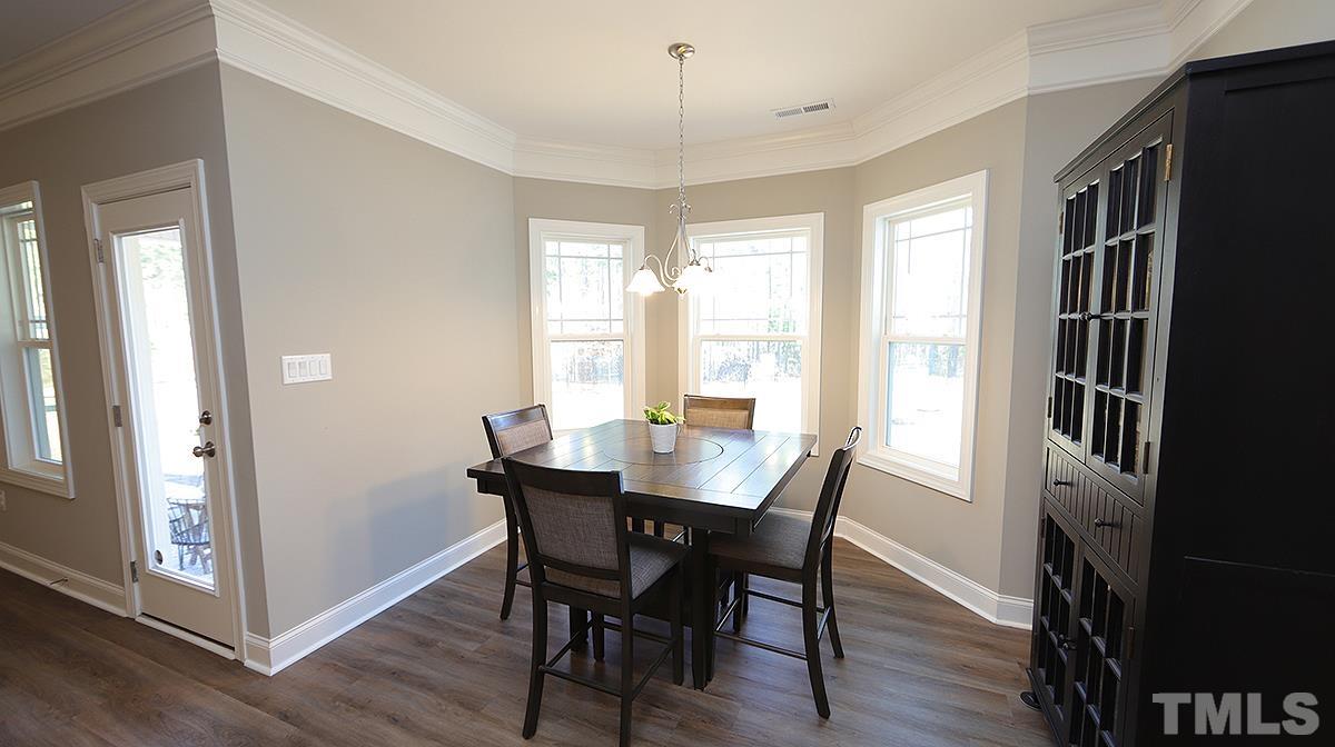 74 Flora Drive Benson, NC 27504 - Photo 16 of 33 a view of a dining room with furniture window and wooden floor