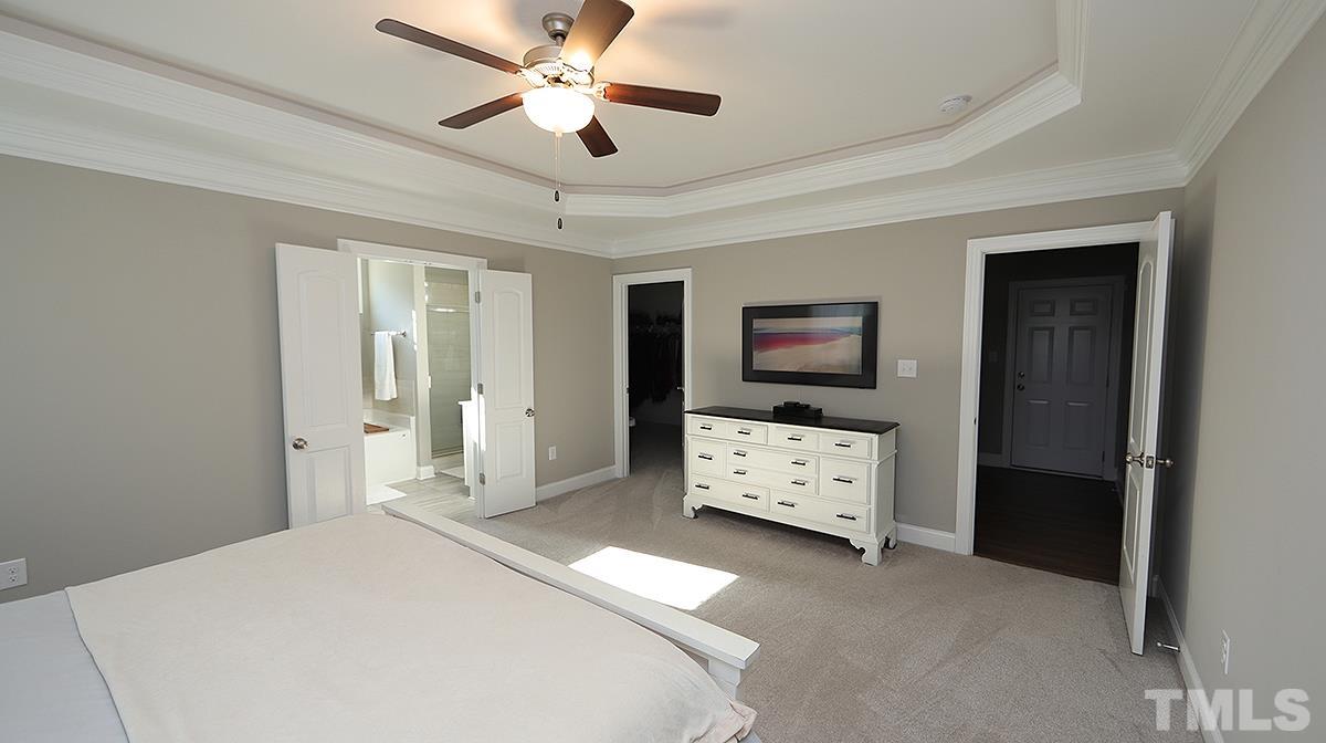 74 Flora Drive Benson, NC 27504 - Photo 18 of 33 a bedroom with a bed and a flat tv screen on dresser