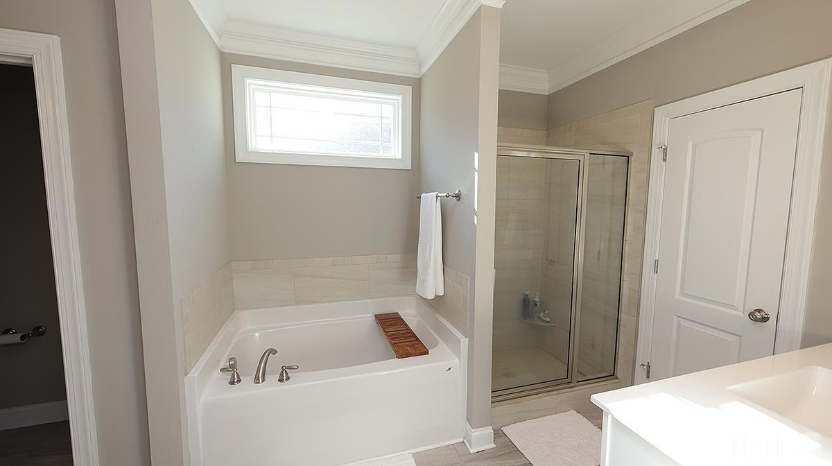 74 Flora Drive Benson, NC 27504 - Photo 20 of 33 a bathroom with a sink a toilet and shower