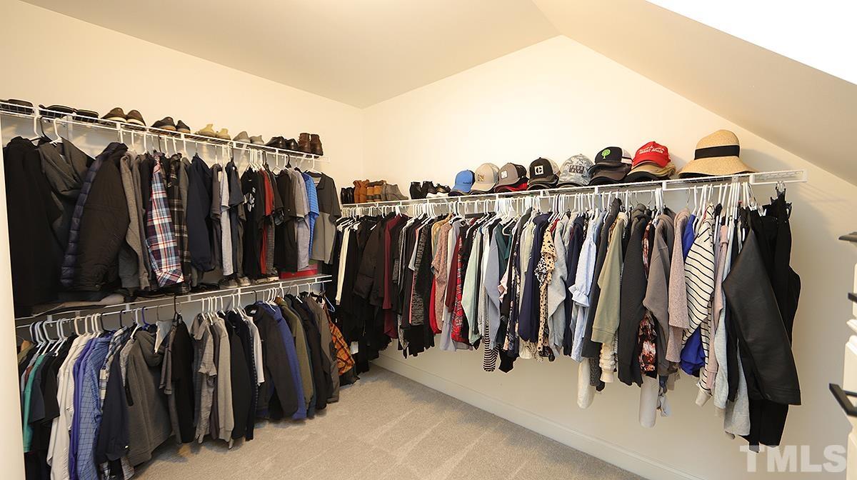 74 Flora Drive Benson, NC 27504 - Photo 21 of 33 a view of walk in closet with clothes and shoes