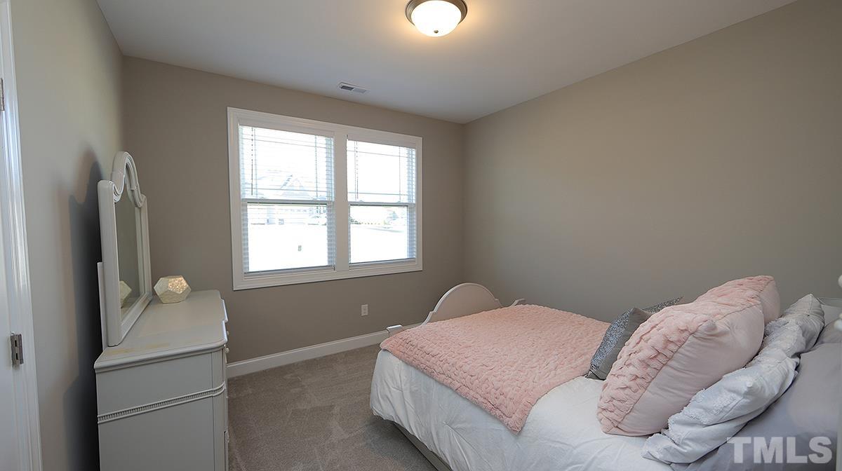 74 Flora Drive Benson, NC 27504 - Photo 23 of 33 a bedroom with a bed and a window