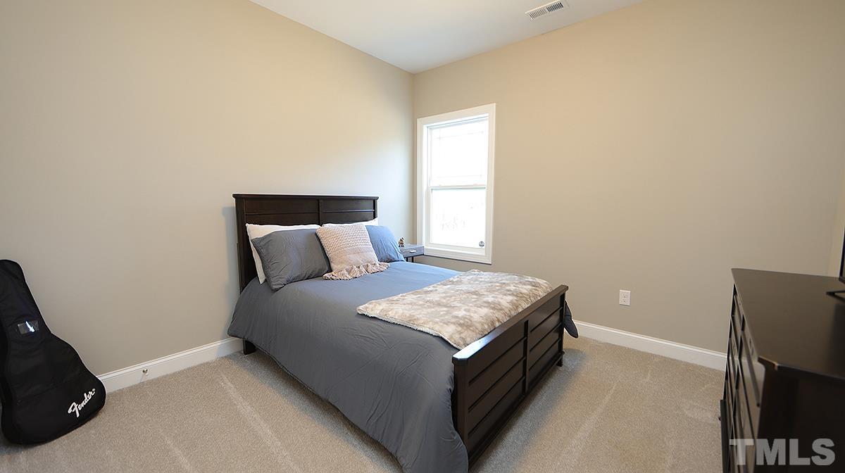 74 Flora Drive Benson, NC 27504 - Photo 25 of 33 a bed room with a bed and a television