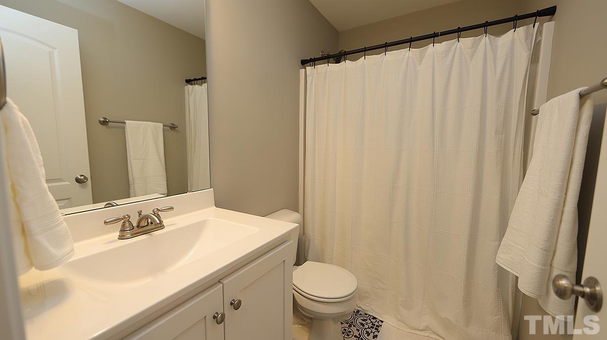74 Flora Drive Benson, NC 27504 - Photo 28 of 33 a bathroom with a sink and a mirror