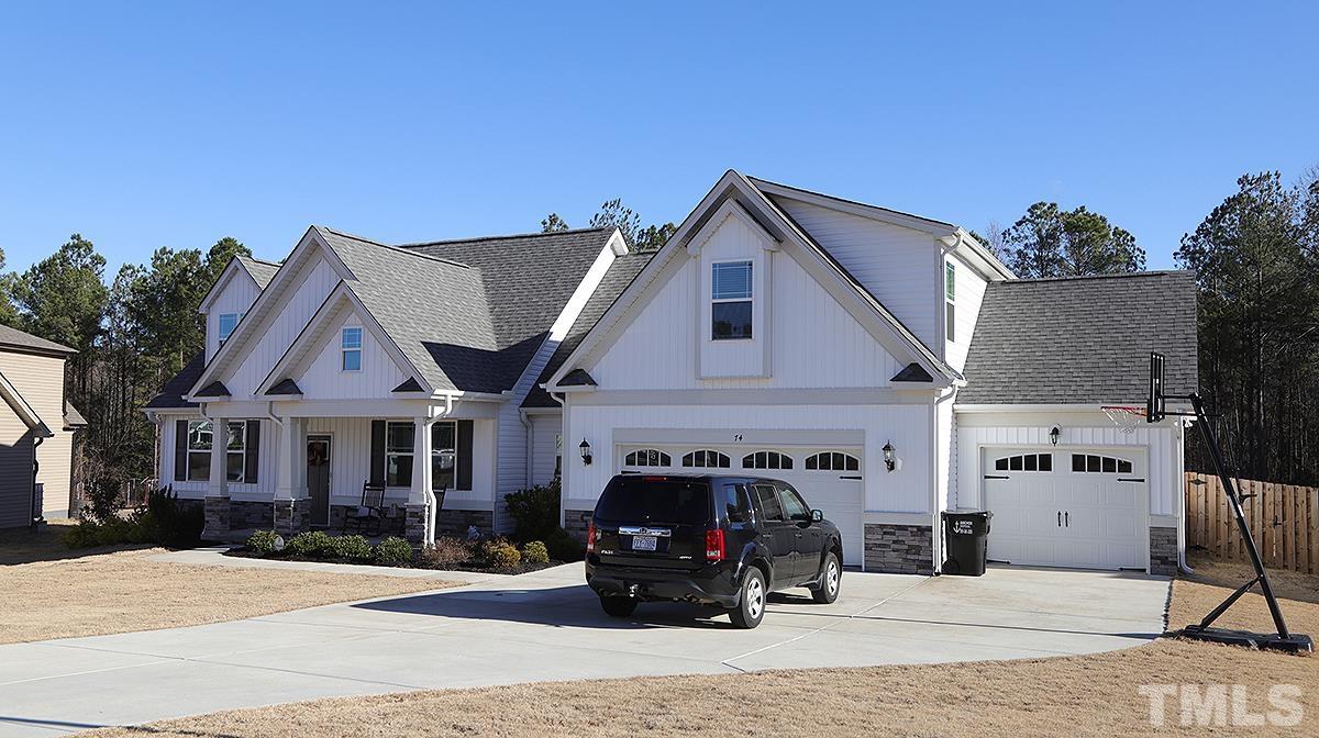 74 Flora Drive Benson, NC 27504 - Photo 3 of 33 a front view of a house with cars parked