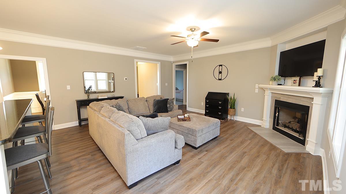 74 Flora Drive Benson, NC 27504 - Photo 10 of 33 a living room with furniture fireplace and flat screen tv