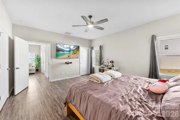 a bedroom with a large bed and a chandelier