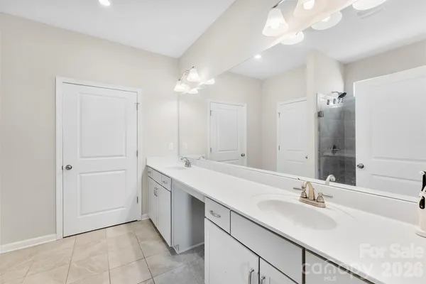a bathroom with a sink a vanity and a mirror