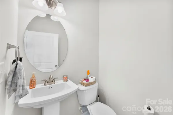 a bathroom with a sink mirror and toilet