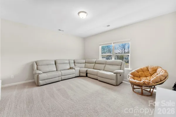 a living room with furniture a rug and a large window
