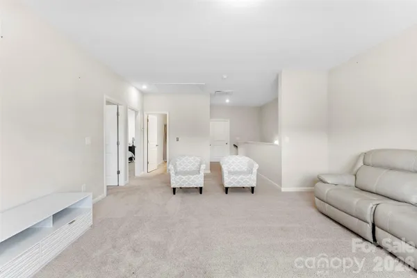 a living room with furniture and white walls
