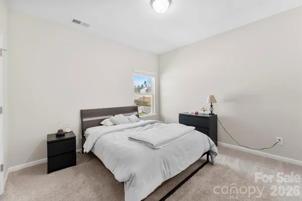 a bedroom with a bed and a lamp