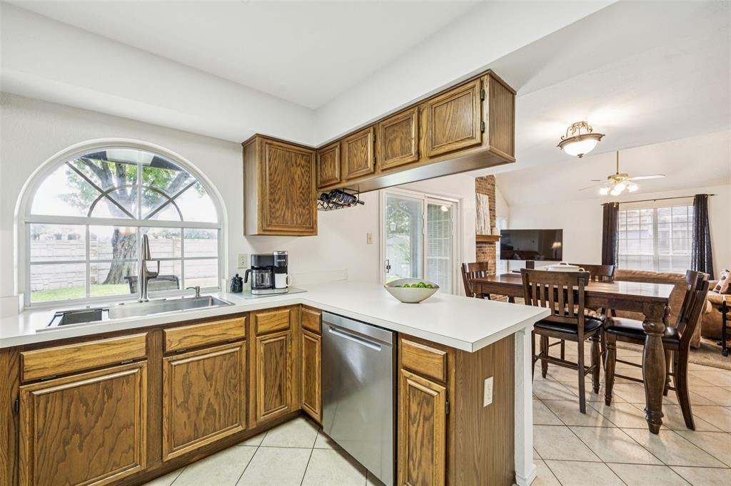 113 Windmill Ridge Drive Rockwall, TX 75032 - Photo 5 of 19 Open-concept layout connects the kitchen to the dining and living areas, with backyard views and great natural light throughout.