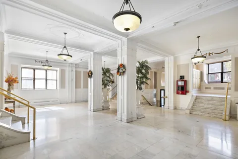 a view of a kitchen with refrigerator and cabinets